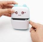 Mini Sticker Printer from سوق كوم showing compact device with paper roll and colorful printed stickers.