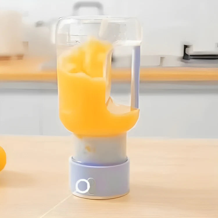 Mini Juicer blender from سوق كوم, compact kitchen tool with a transparent container and blending blade for fresh juice.