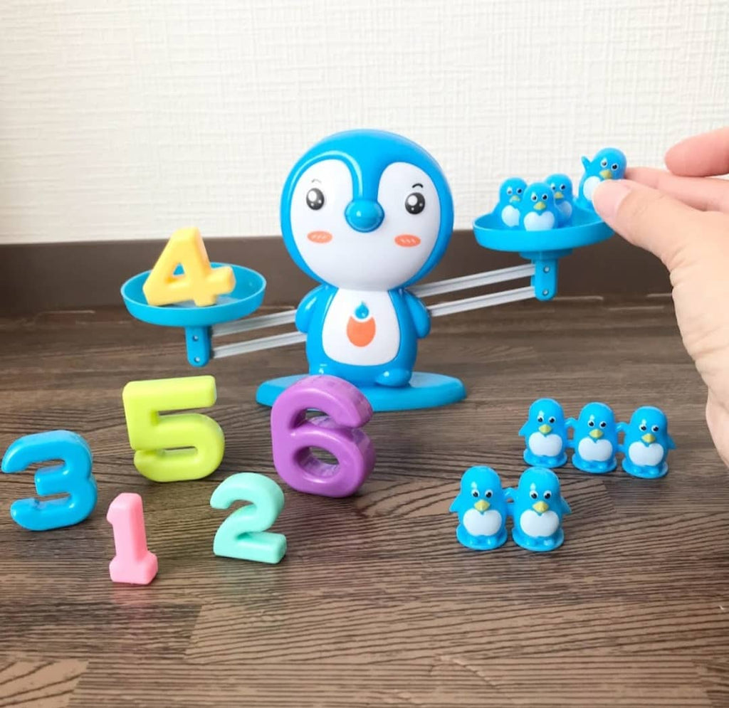 Educational number balance game toy for children, featuring colorful number blocks and a wooden balance scale for learning.