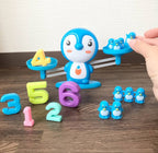 Educational number balance game toy for children, featuring colorful number blocks and a wooden balance scale for learning.