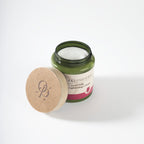 Cream jar of أولي باراديس لبن جمل ورد for skincare, featuring a pink and white packaging with Arabic text.