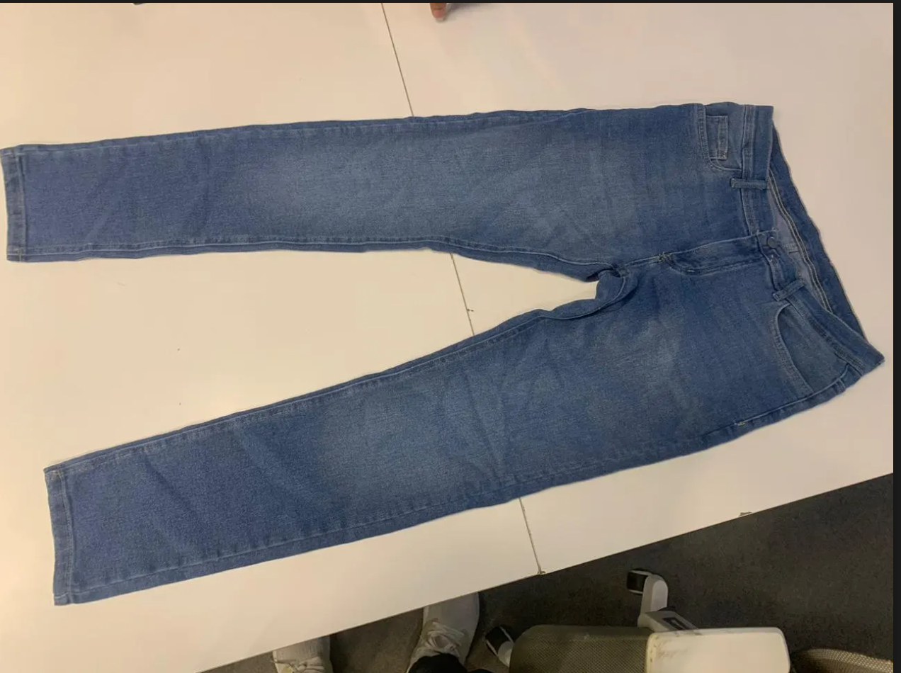 Stylish men's blue denim jeans from سوق كوم, showcasing a classic fit and detailed stitching on the front.