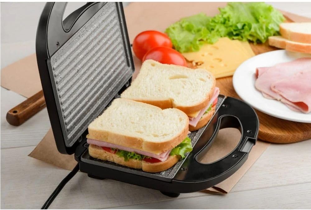 Sandwich maker Rafe from سوق كوم kitchen tools, showing the appliance with bread slices and grilling plates.