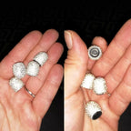 Shiny crystal car tire valve cover accessory with reflective design, used for enhancing vehicle wheels' appearance.