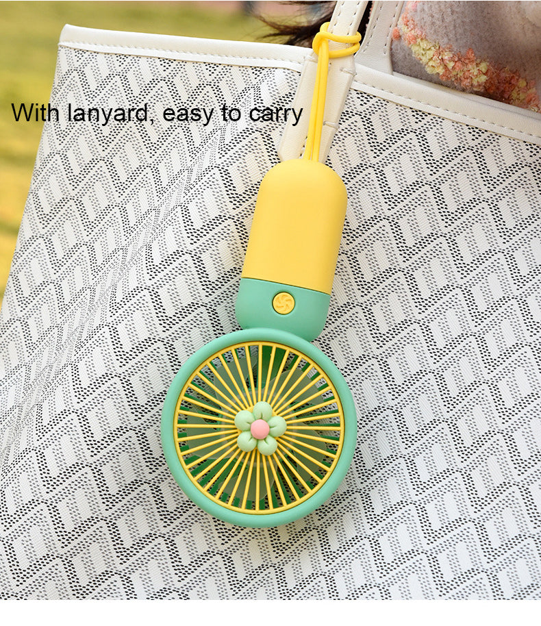 Mini portable fan from سوق كوم, compact personal cooling device with adjustable blades and ergonomic handle for easy use.