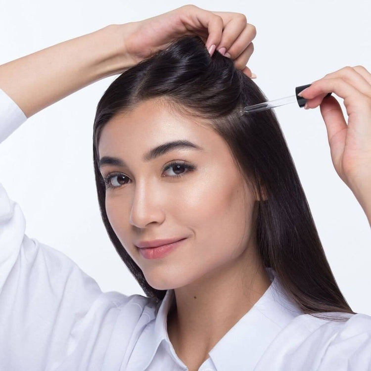 Nourishing hair serum from roots by سوق كوم, featuring a sleek bottle with dropper for easy application.