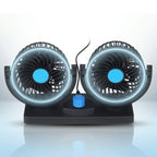 Dual-head USB car fan accessory showing two rotating fan heads mounted inside a vehicle for cooling.